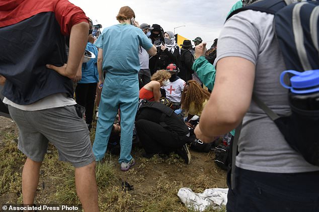 Protest medics tend to an injured demonstrator who police believe was shot by a fellow protester while on Interstate 225 in Aurora on Saturday
