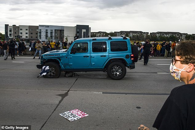 Investigators are still trying to determine how and why the driver of the Jeep passed through barricades before driving into the crowd of protesters on Interstate 225